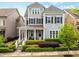 Charming two-story home with gray siding, manicured landscaping, and a welcoming front porch at 4020 Declaration Dr, Roswell, GA 30076