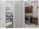 Organized laundry room with ample shelving and modern washer and dryer at 4020 Declaration Dr, Roswell, GA 30076