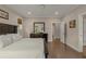 Serene bedroom with hardwood floors, neutral walls, and an ensuite bathroom at 4020 Declaration Dr, Roswell, GA 30076