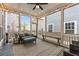 Cozy screened-in patio with comfortable seating, string lights, and view of the backyard at 4020 Declaration Dr, Roswell, GA 30076