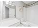 Clean bathroom featuring a vanity, toilet, and tub/shower with white tile surround at 4746 Chamblee Dunwoody Rd, Atlanta, GA 30338