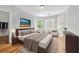 Comfortable bedroom with light colored walls, hardwood floor, and three windows at 4746 Chamblee Dunwoody Rd, Atlanta, GA 30338