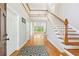 Grand foyer with hardwood floors, staircase, and an open view to the living area at 4746 Chamblee Dunwoody Rd, Atlanta, GA 30338