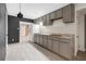 Updated kitchen features modern gray cabinets, tile flooring, and stainless steel appliances at 4746 Chamblee Dunwoody Rd, Atlanta, GA 30338