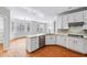 Modern kitchen featuring white cabinets, stainless steel appliances, and hardwood floors at 4746 Chamblee Dunwoody Rd, Atlanta, GA 30338