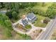 Aerial view of a large home with mature trees, lush landscaping, and a long driveway at 10192 Shallowford Rd, Roswell, GA 30075