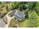 Aerial view of charming two story home with mature trees and lush landscaping at 10192 Shallowford Rd, Roswell, GA 30075