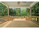 View from the wooden deck of a charming yard with raised garden beds and a lush green forest backdrop at 10192 Shallowford Rd, Roswell, GA 30075