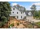 Exterior view of a home with a back porch, wooden deck, raised garden beds, and a fenced yard at 10192 Shallowford Rd, Roswell, GA 30075