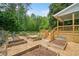 Discover a serene backyard featuring a wooden deck and raised garden beds, perfect for outdoor living at 10192 Shallowford Rd, Roswell, GA 30075