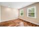 Neutral bedroom with hardwood floors, white baseboard trim, and lots of natural light at 10192 Shallowford Rd, Roswell, GA 30075