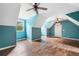 Turquoise bedroom with hardwood floors, vaulted ceilings, and two ceiling fans at 10192 Shallowford Rd, Roswell, GA 30075