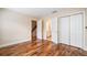 Bedroom with hardwood floors; view to stairway and ample closet space at 10192 Shallowford Rd, Roswell, GA 30075