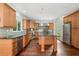 Modern kitchen with stainless steel appliances, wood cabinets, and a center island for food preparation at 10192 Shallowford Rd, Roswell, GA 30075