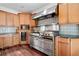 Gourmet kitchen with professional-grade stainless steel appliances and custom tile backsplash at 10192 Shallowford Rd, Roswell, GA 30075