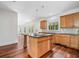 Kitchen island with sink overlooks backyard; wood cabinets and stainless appliances at 10192 Shallowford Rd, Roswell, GA 30075