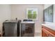 Bright laundry room with updated appliances and a large window providing natural light at 10192 Shallowford Rd, Roswell, GA 30075