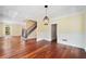 Elegant living room with hardwood floors, large windows, and classic white wainscoting and trim at 10192 Shallowford Rd, Roswell, GA 30075