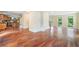 Spacious open-concept living room flows into the kitchen with gleaming hardwood floors and natural light at 10192 Shallowford Rd, Roswell, GA 30075