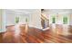 Spacious living area featuring gleaming hardwood floors, large windows, and elegant trim at 10192 Shallowford Rd, Roswell, GA 30075