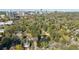 An aerial shot showcases a lush, green neighborhood with a pond and beautiful homes with the city skyline in the distance at 3 Demorest Ne Ave, Atlanta, GA 30305