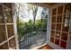 Private balcony view of manicured backyard with stone patio through open french doors at 3 Demorest Ne Ave, Atlanta, GA 30305