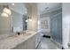 Beautiful bathroom with granite counters, a walk-in shower, and black-and-white tiled floors at 3 Demorest Ne Ave, Atlanta, GA 30305