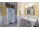 Well-lit bathroom with pedestal sink, beadboard paneling, and patterned window treatment at 3 Demorest Ne Ave, Atlanta, GA 30305