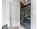 Luxurious bathroom featuring glass shower with marble tile surround and marble bench at 3 Demorest Ne Ave, Atlanta, GA 30305
