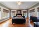 Cozy bedroom featuring hardwood floors, two windows and a black bedroom set at 3 Demorest Ne Ave, Atlanta, GA 30305