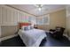 Comfortable bedroom with hardwood floors, many windows, and cozy reading chair at 3 Demorest Ne Ave, Atlanta, GA 30305