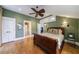 Comfortable bedroom featuring hardwood floors, ceiling fan, and ensuite bathroom access at 3 Demorest Ne Ave, Atlanta, GA 30305