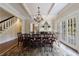 Formal dining room features coffered ceiling, hardwood floors, and adjacent staircase at 3 Demorest Ne Ave, Atlanta, GA 30305