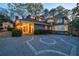 Charming home with well-manicured landscaping, a circular driveway, and inviting front entrance with double doors at 3 Demorest Ne Ave, Atlanta, GA 30305