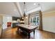Elegant game room with vaulted ceiling, wet bar, hardwood floors, and large windows at 3 Demorest Ne Ave, Atlanta, GA 30305