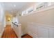 Bright hallway with wood floors, stylish wainscoting, and staircase to the next level at 3 Demorest Ne Ave, Atlanta, GA 30305