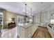 Spacious kitchen boasts a large island, stainless steel appliances, and elegant chandelier lighting at 3 Demorest Ne Ave, Atlanta, GA 30305