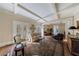 Open living room with coffered ceilings, hardwood floors and French doors leading outside at 3 Demorest Ne Ave, Atlanta, GA 30305
