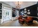 Cozy library with built-in bookshelves, dark walls, and comfortable armchairs at 3 Demorest Ne Ave, Atlanta, GA 30305