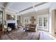Bright living room with coffered ceilings, fireplace, hardwood floors and French doors at 3 Demorest Ne Ave, Atlanta, GA 30305