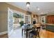 Bright dining room extends to outdoor patio with open door, elegant fireplace, and comfortable seating at 3 Demorest Ne Ave, Atlanta, GA 30305