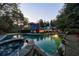 A stunning backyard pool with a spa and beautiful landscaping offers a tranquil oasis at this luxury home at 3 Demorest Ne Ave, Atlanta, GA 30305