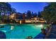 Backyard pool reflecting the house. The pool includes a jacuzzi and the house has a brick chimney at 3 Demorest Ne Ave, Atlanta, GA 30305