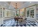 Bright sunroom with a beautiful chandelier and large windows overlooking the garden at 3 Demorest Ne Ave, Atlanta, GA 30305