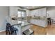 Bright kitchen with white cabinets, granite countertops, stainless steel appliances, and hardwood floors at 3284 Bakers Mill Ct, Dacula, GA 30019