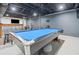 Finished basement featuring a blue pool table and a bar area for entertaining at 369 Arnold Mill Rd, Woodstock, GA 30188