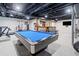 Finished basement with a pool table, exercise equipment, and bar for entertainment at 369 Arnold Mill Rd, Woodstock, GA 30188
