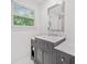 Bathroom featuring gray vanity with marble countertop and modern fixtures at 369 Arnold Mill Rd, Woodstock, GA 30188