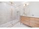 Bathroom with glass shower, pebble floor, and light wood vanity at 369 Arnold Mill Rd, Woodstock, GA 30188