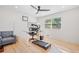 Bright bedroom features hardwood floors, ceiling fan, and a desk area with a window view at 369 Arnold Mill Rd, Woodstock, GA 30188